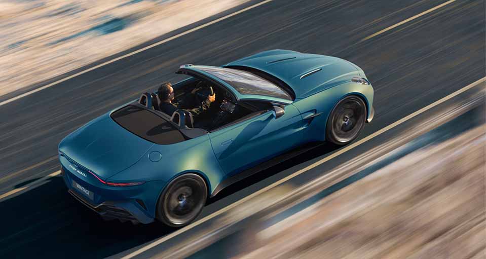 sky view Vantage Roadster driving down road