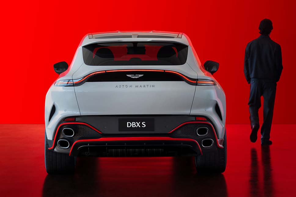 Aston Martin DBXS rear view with customer walking beside